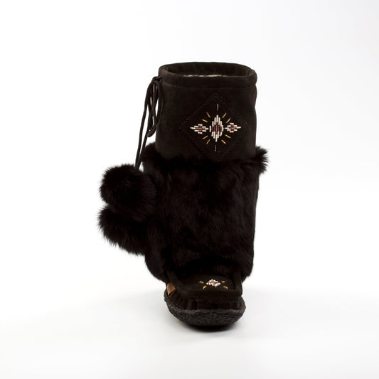 Black fur boot with decorative emblem on a white background