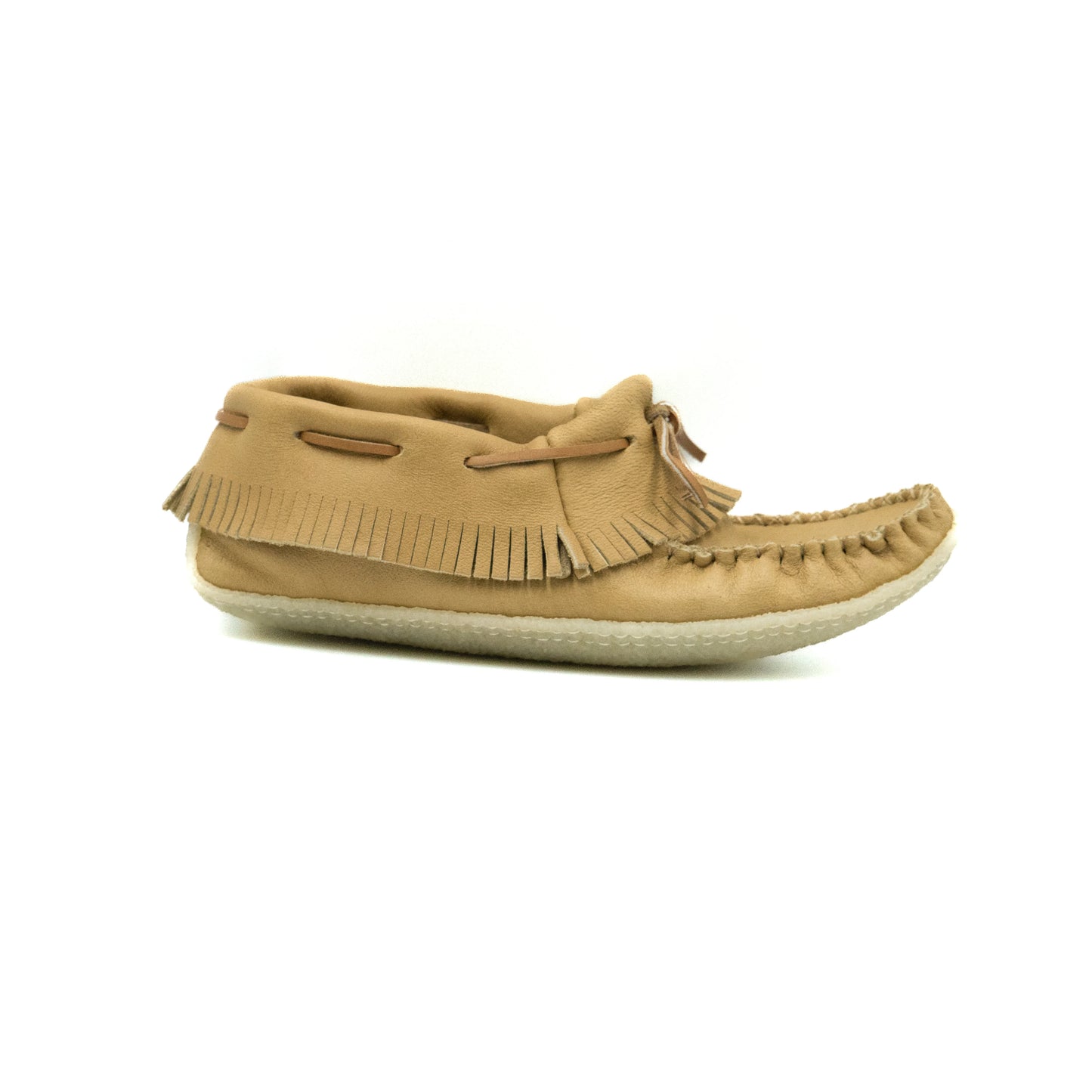 Tan moccasin shoe with fringes on a white background