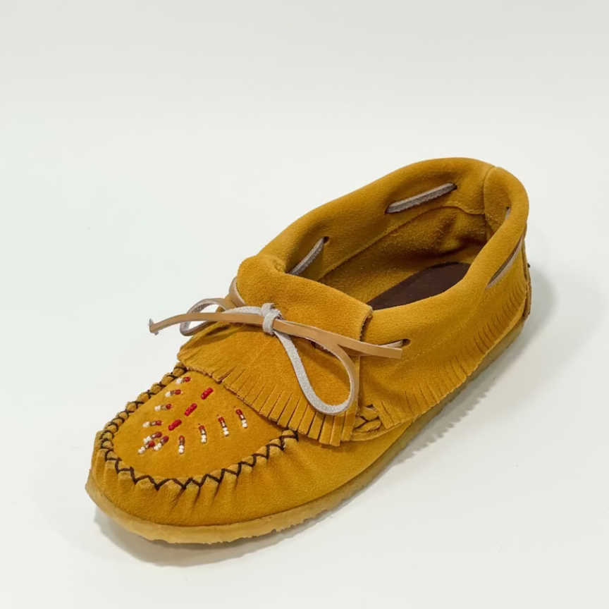 Yellow moccasin shoe on a textured white background