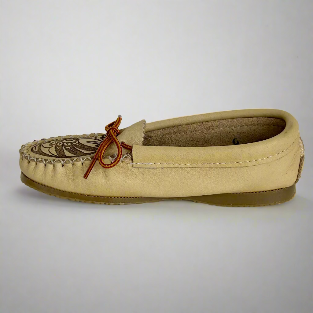 Beige moccasin shoe with brown bow on a white background