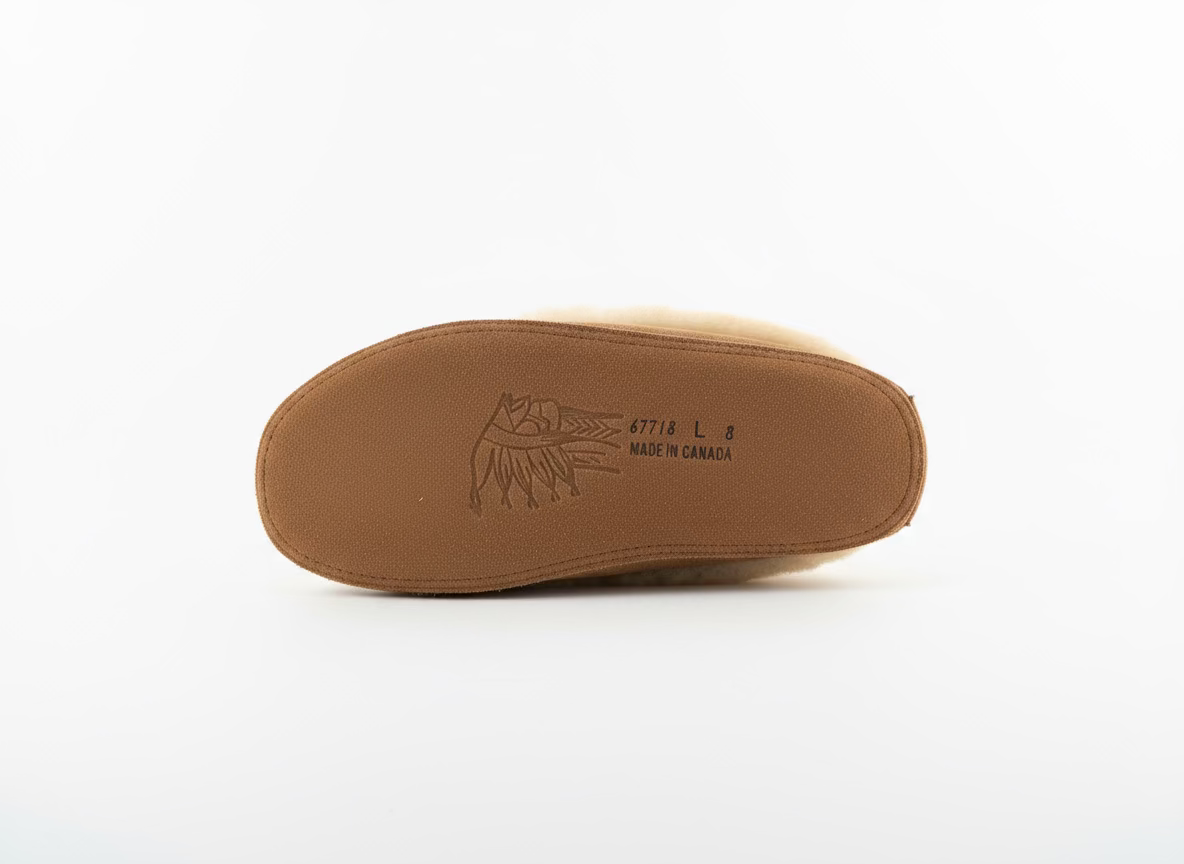 Brown shoe insole with brand logo on a white surface