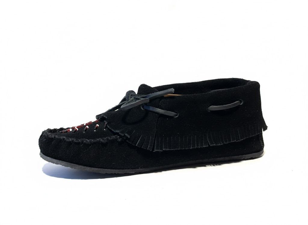Black moccasin shoe with fringes on a white background