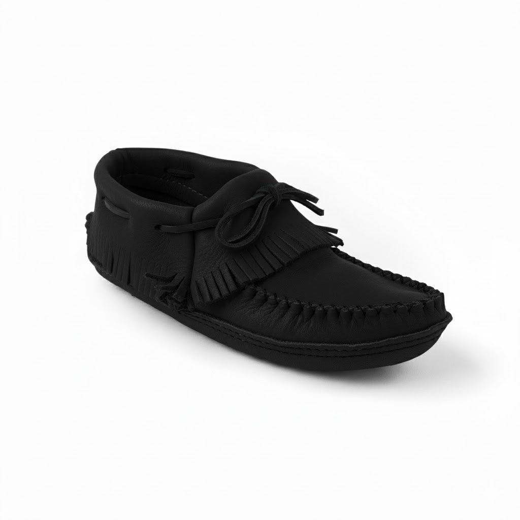 Black moccasin shoe with fringes on a white background