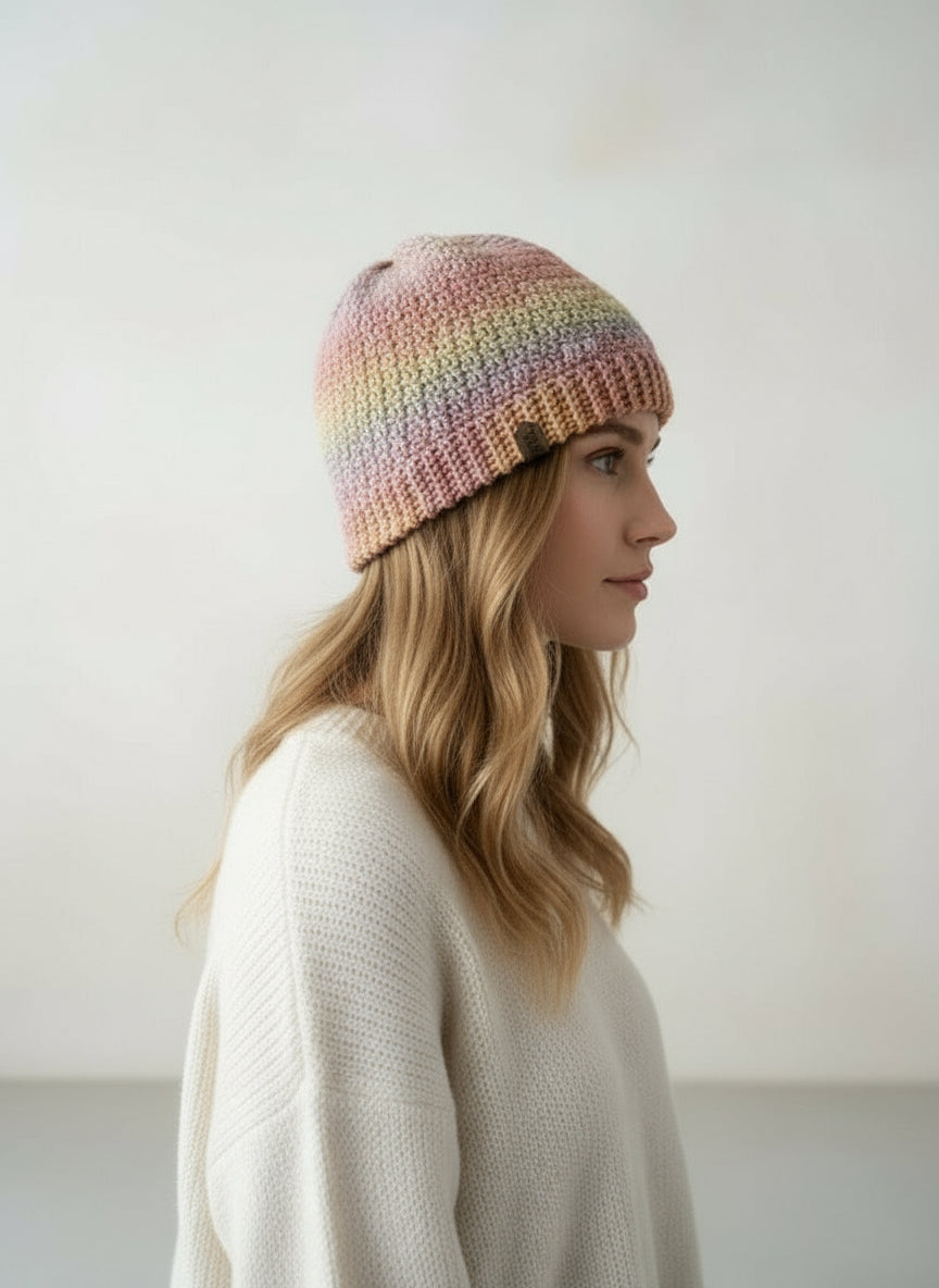 Woman wearing a colorful knit hat with an inset showing the back view.