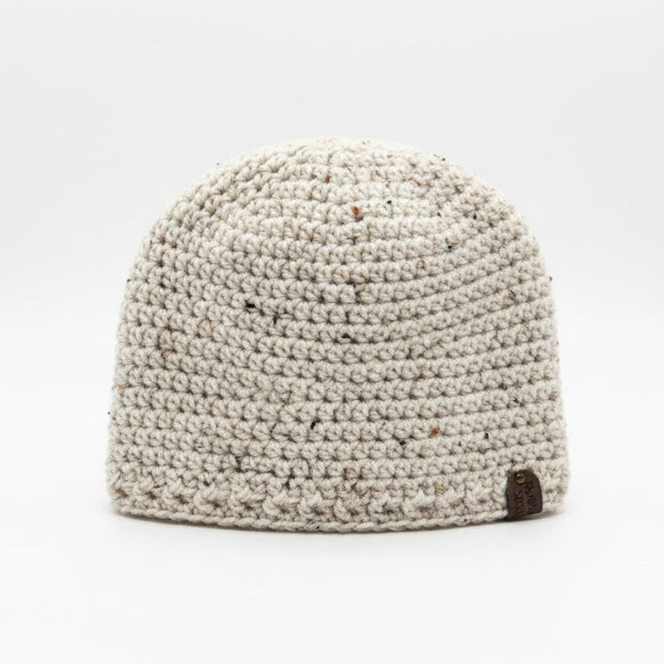 Beige crocheted beanie on a white background