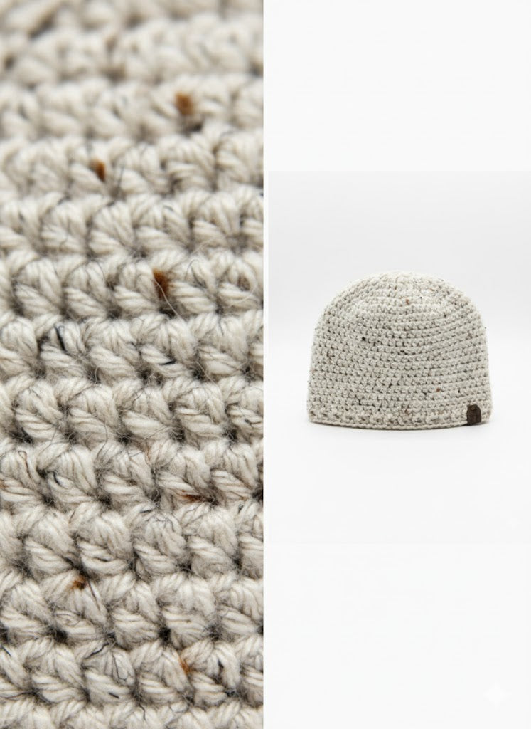 Crocheted blanket and beanie on a white background