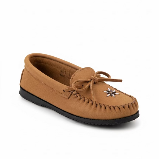 Brown slip-on shoe with a decorative star on a white surface.