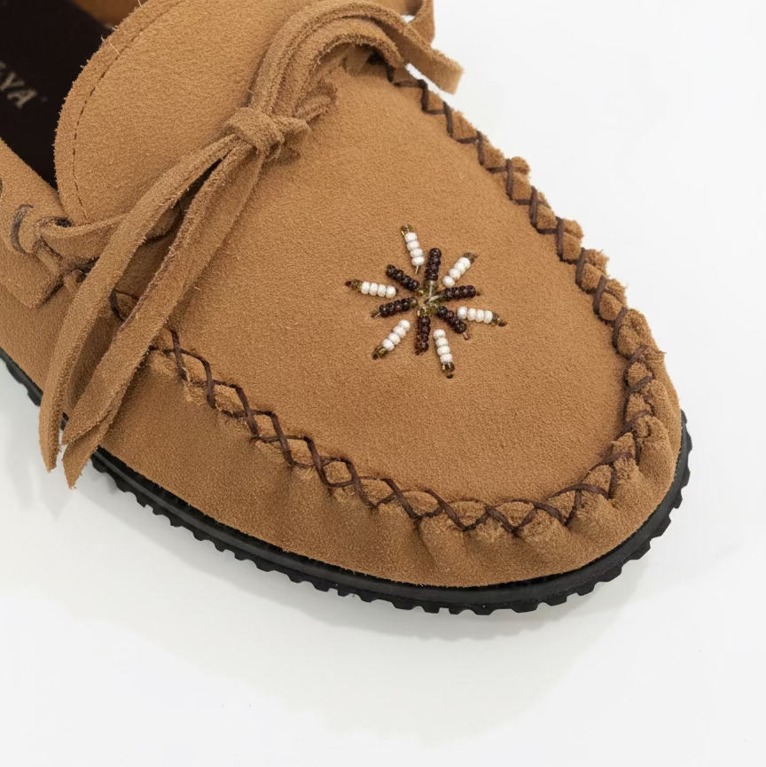 Brown moccasin shoe with decorative star pattern on a white background