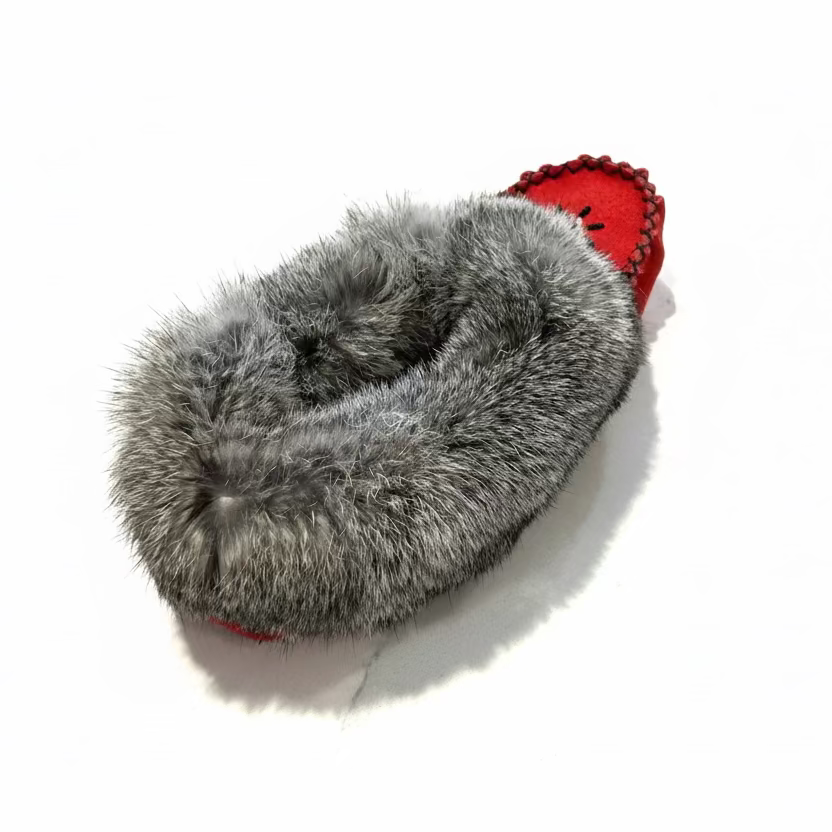 Gray fuzzy slippers on a light marble surface