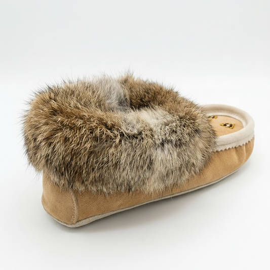 Tan sheepskin slipper with fur trim on a white background