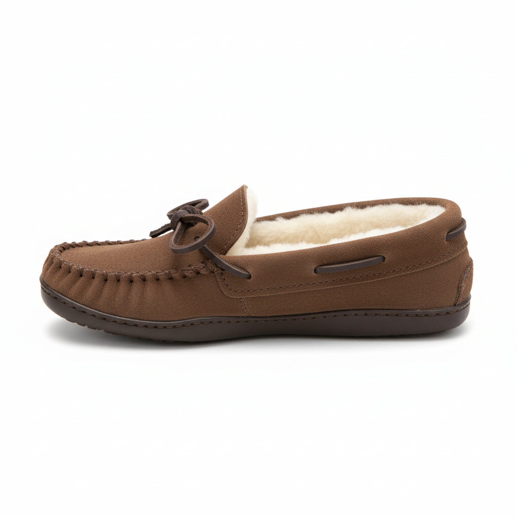 Brown moccasin slippers with sheepskin lining on a white surface.