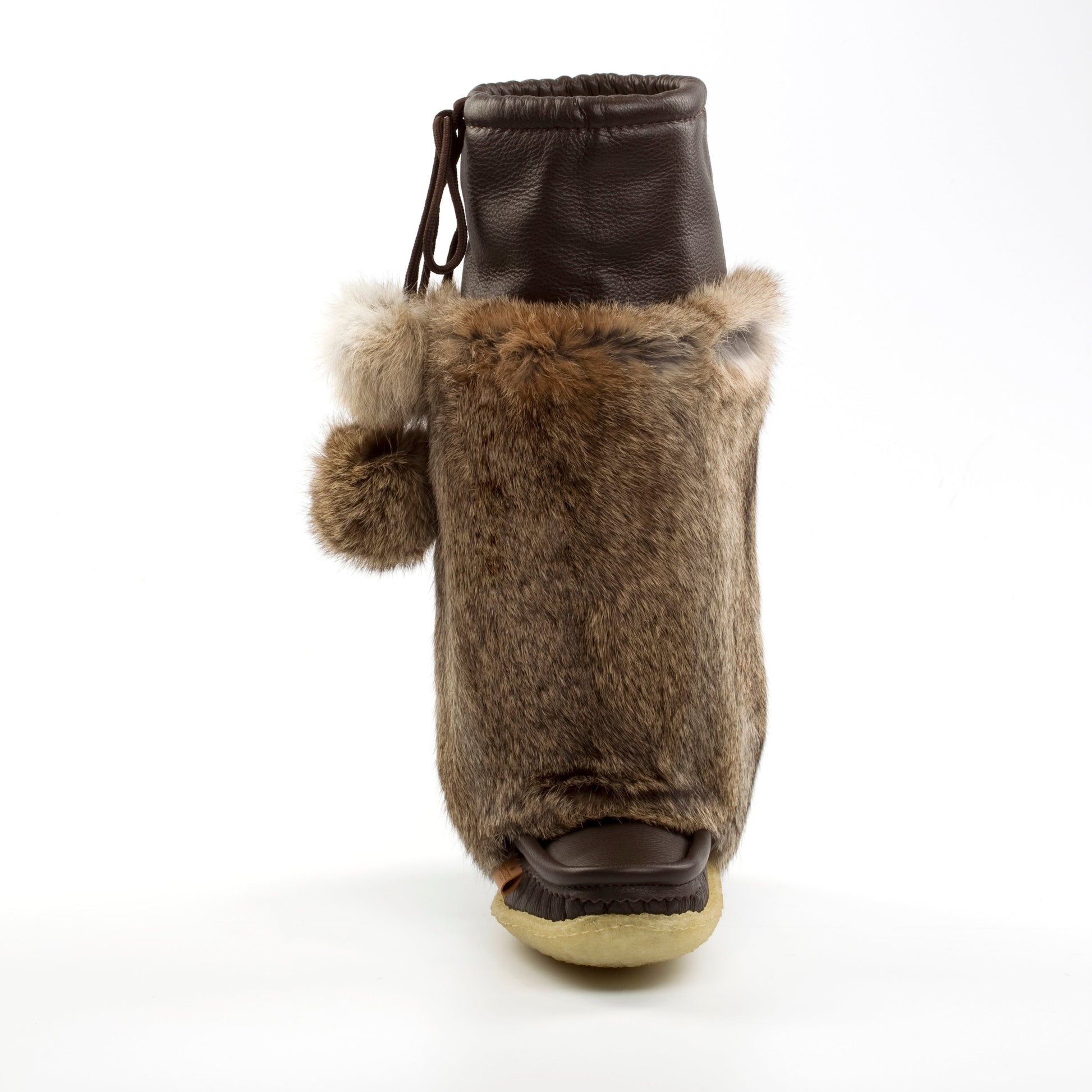 Brown fur boot with a white sole on a white background