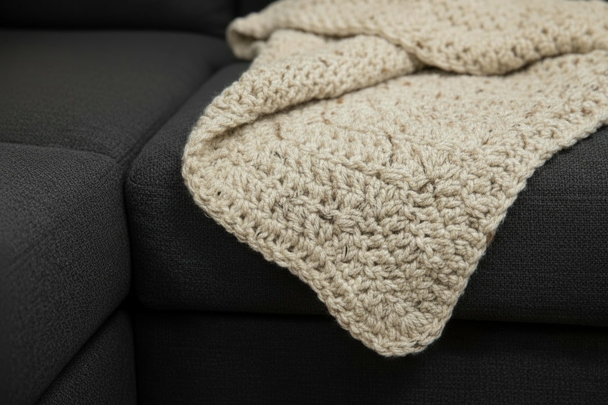 Close-up of a beige knitted fabric on a couch surface