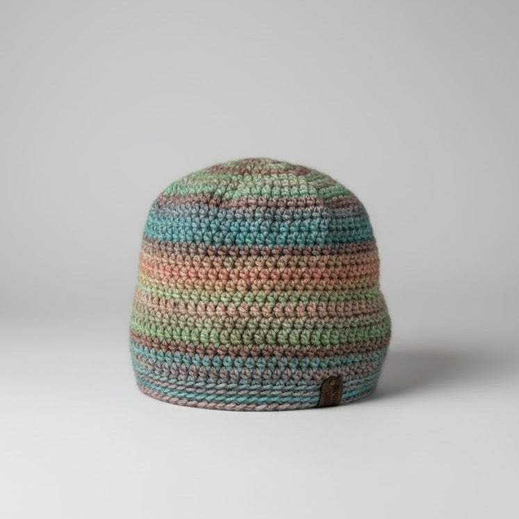 Multicolored striped beanie on a gray background