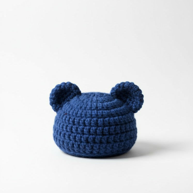 Blue knitted bear hat on a white background