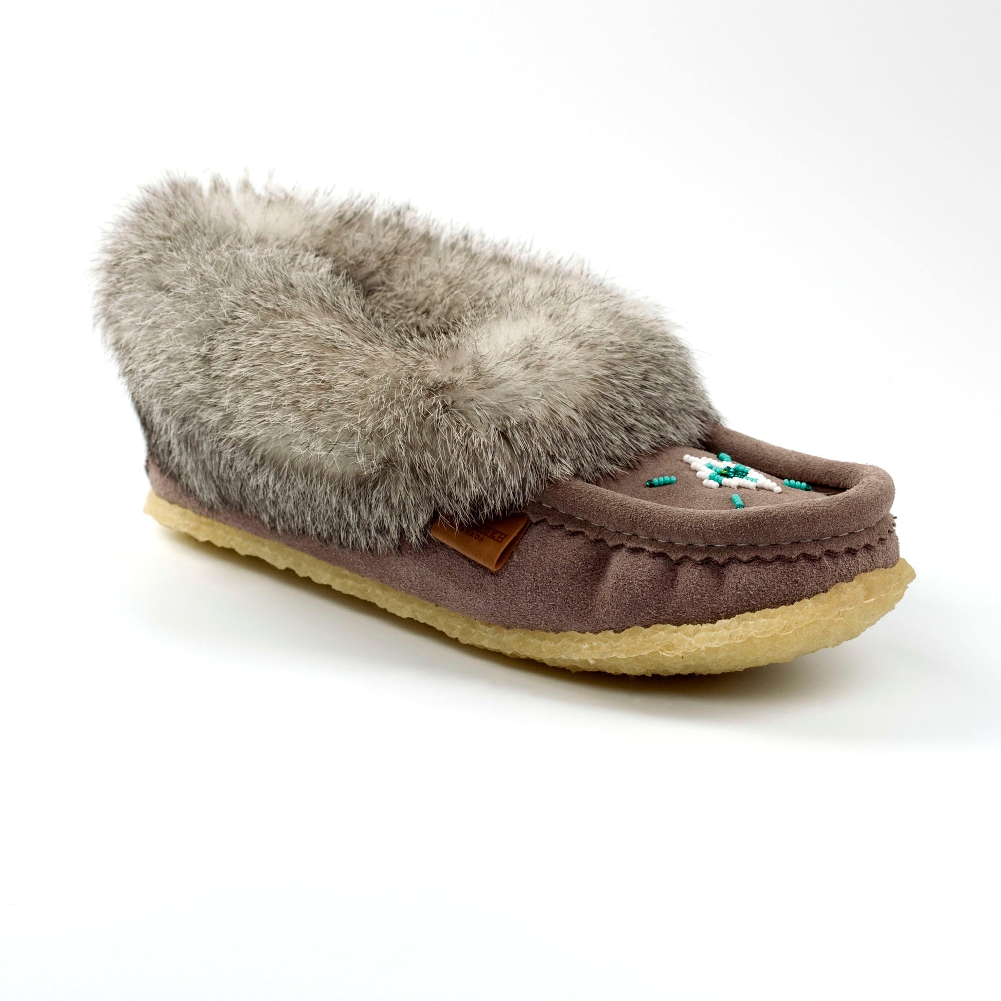 grey slipper with gray fur on a white background