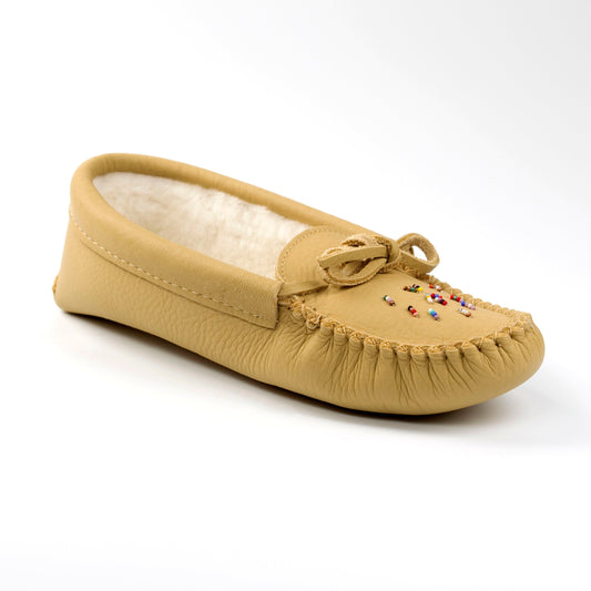 A women's beaded moccasin with a deer tan color, handcrafted with a plush fleece lining and a padded sole, featuring intricate beadwork on the vamp.