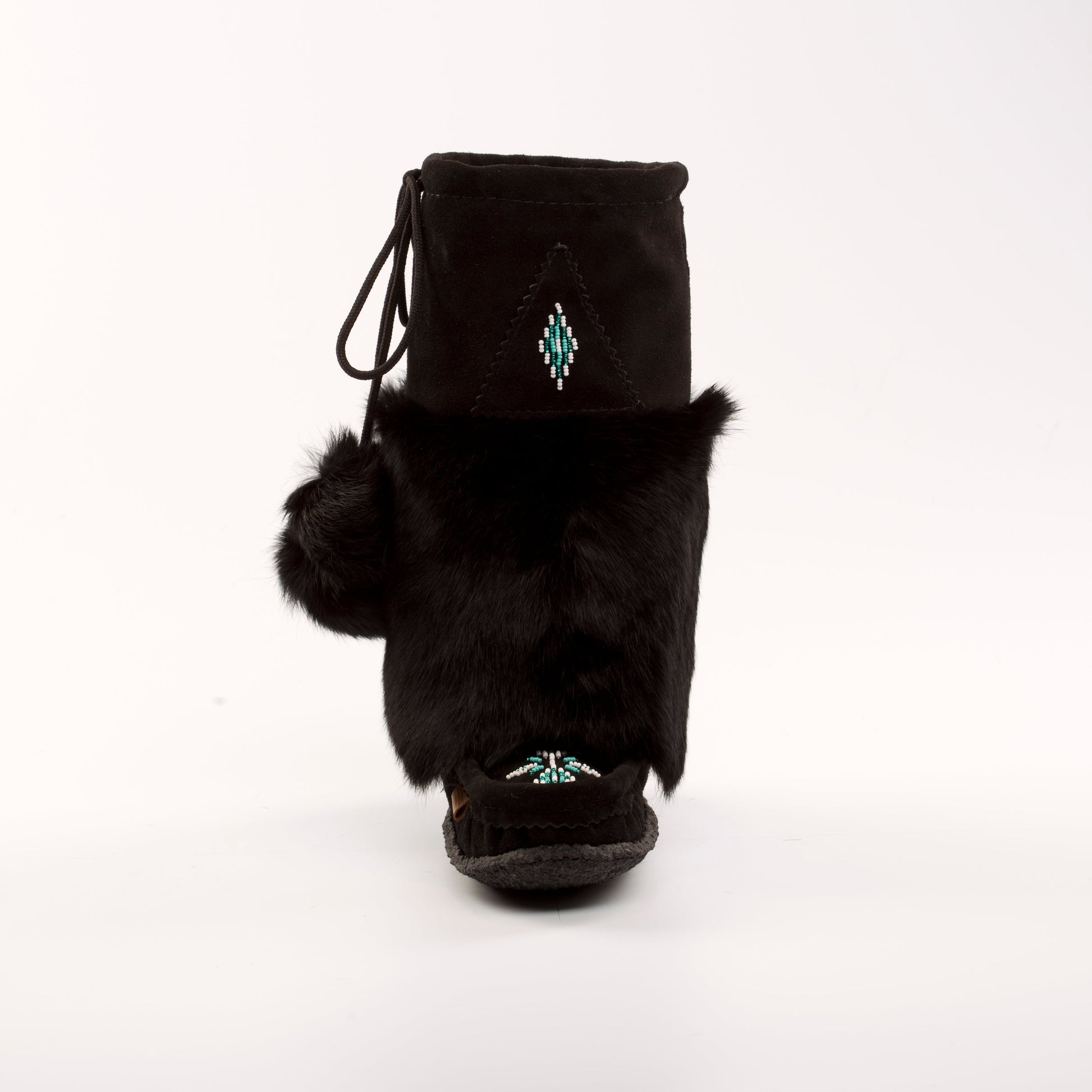 Black fur-lined boot with pom-poms on a white background