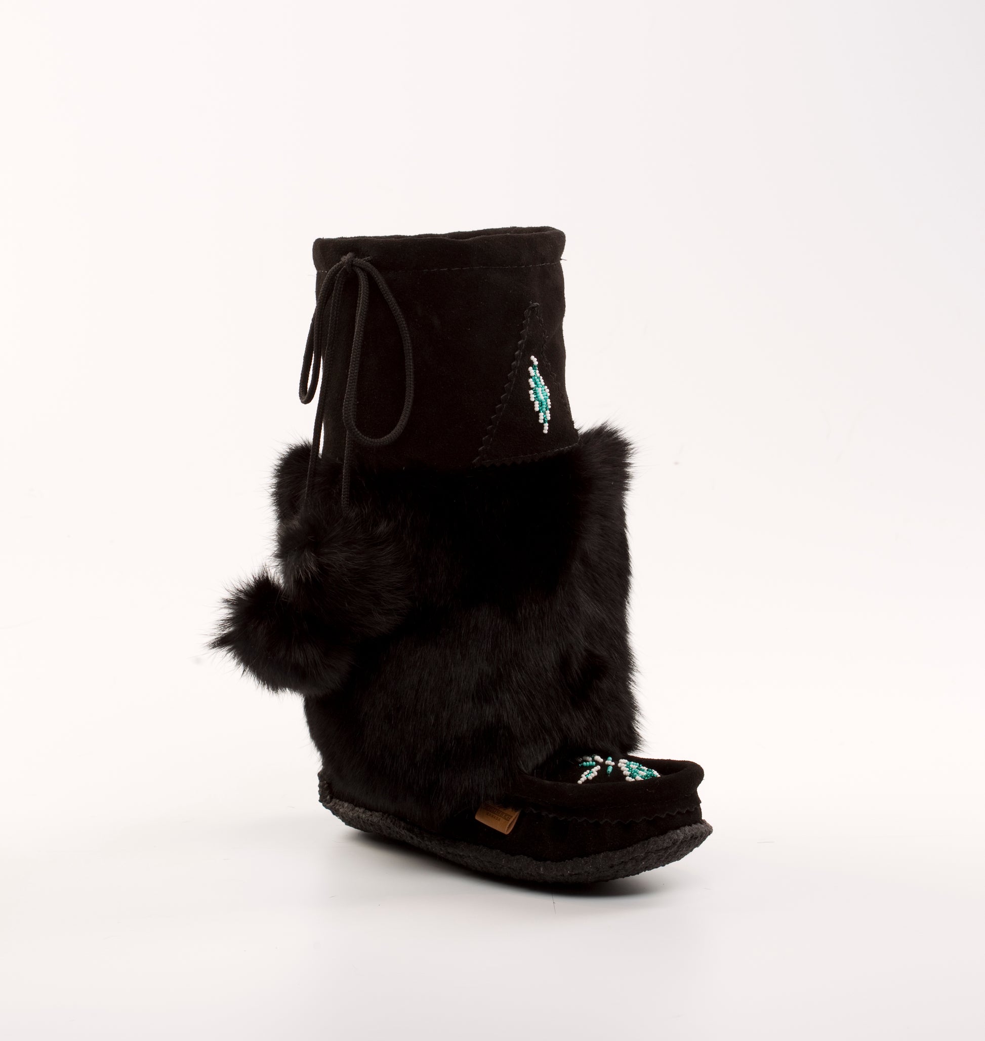 Black mukluk boot with fur trim on a white background