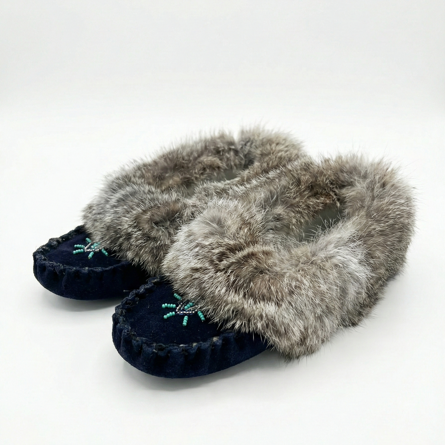 Pair of slippers with fur trim on a white background
