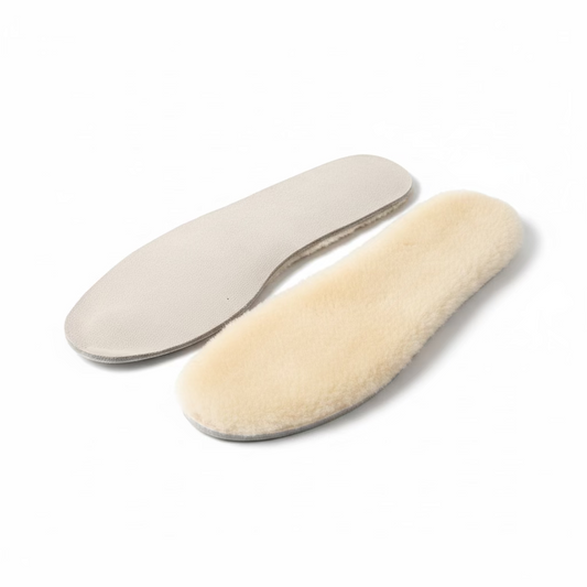 Two pairs of white shoe inserts on a white surface