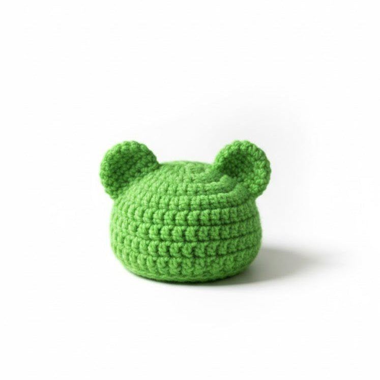 Green knitted hat with ears on a white background