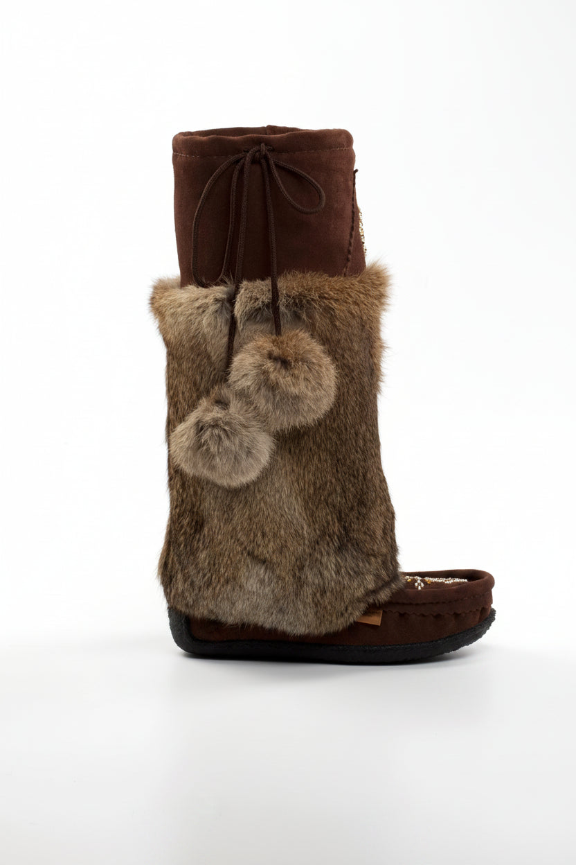 Brown fur boot with snowflake bead pattern on a white background