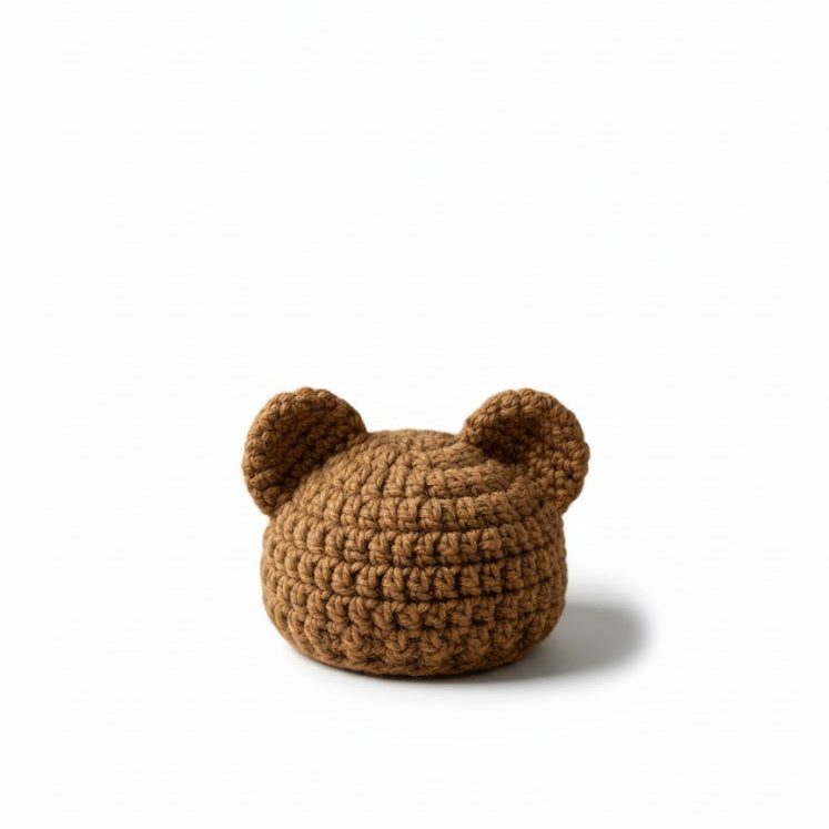 Brown knitted hat with bear ears on a white background