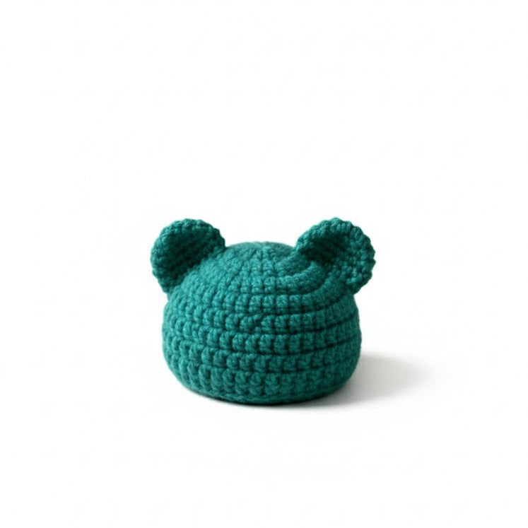 Teal crochet bear hat on a white background