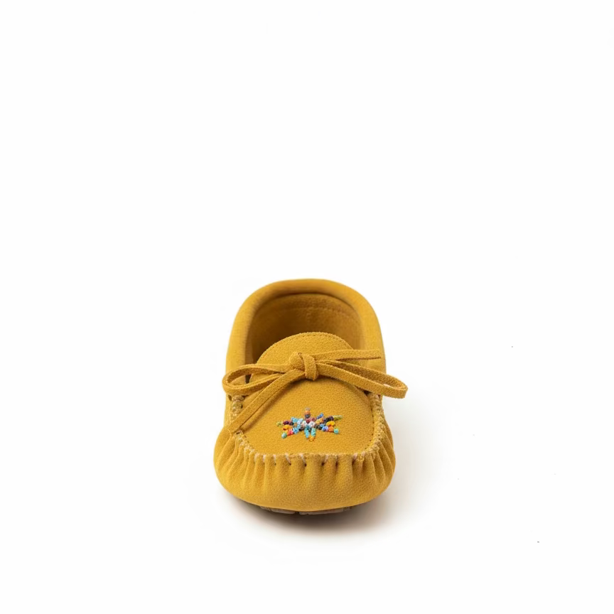 Yellow shoe with a decorative bow on a white background