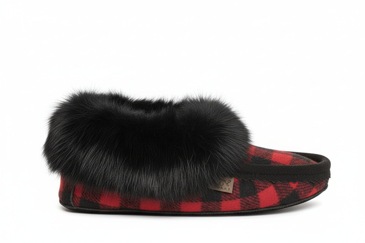 Slipper with black fur trim and red plaid pattern on a white background