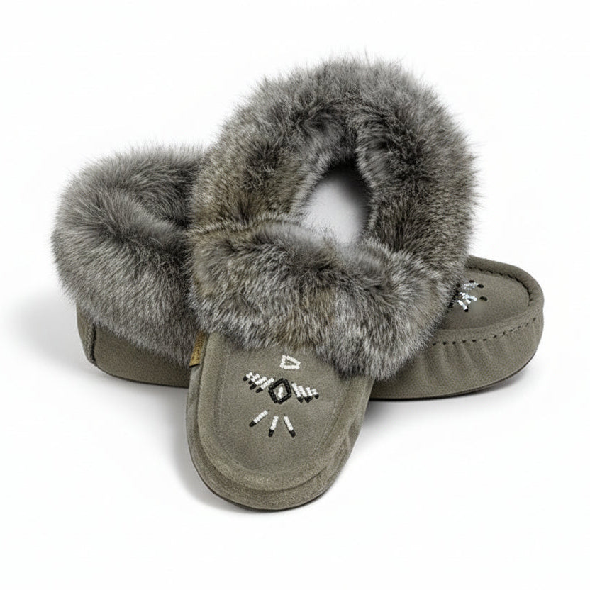 Pair of gray slippers with fur trim on a white background