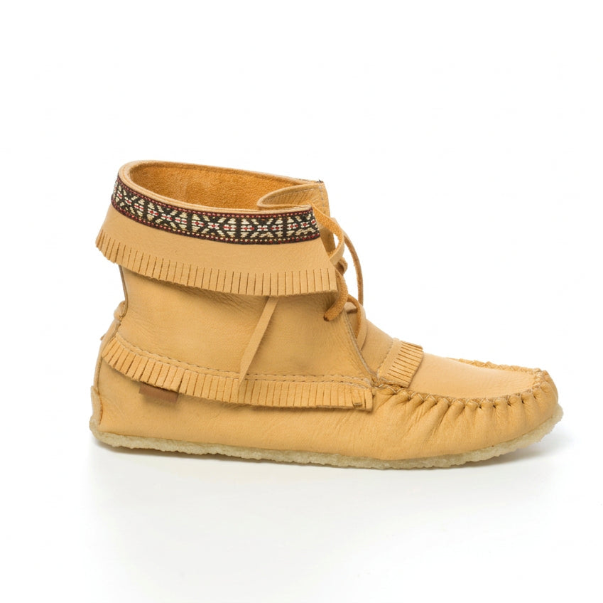 Tan moccasin-style shoe with fringes and a patterned band on a white background