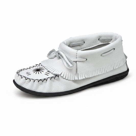 White moccasin shoe with black details on a white background