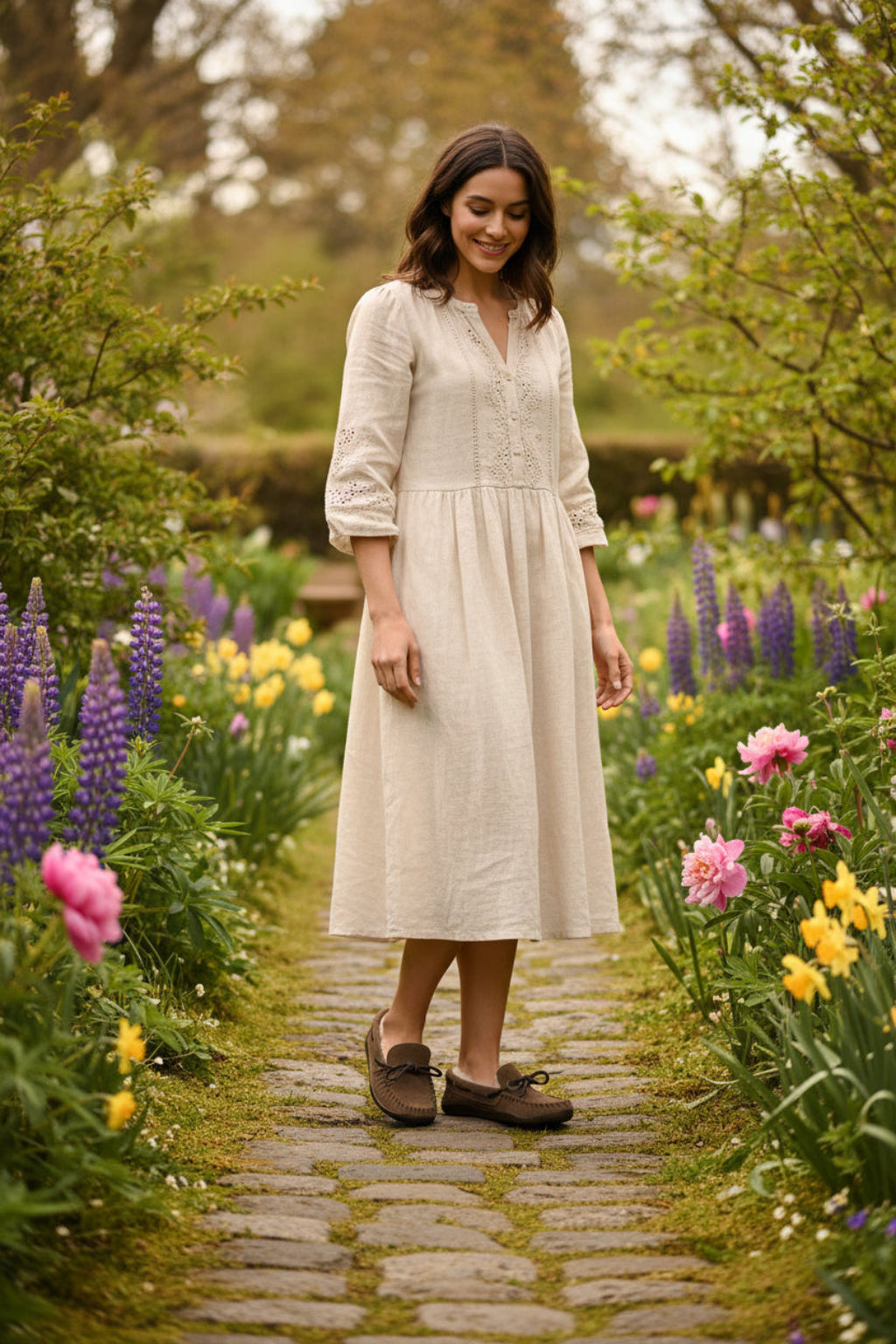 woman wearing moccasins in a flower garden wearing a spring outfit